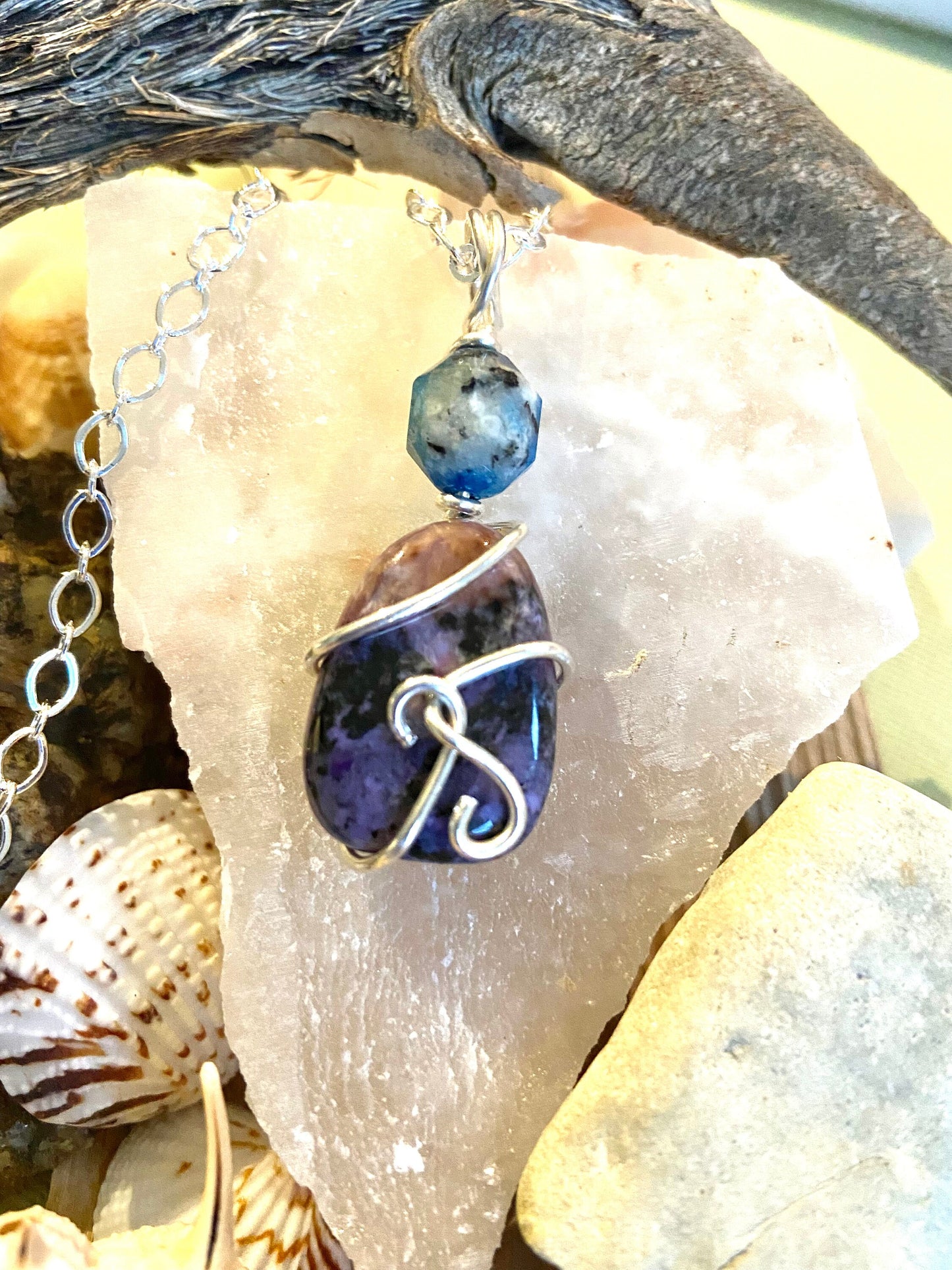 Two beautiful gemstones K2 and Lepidolite intertwined with sterling silver to form a lovely pendant.