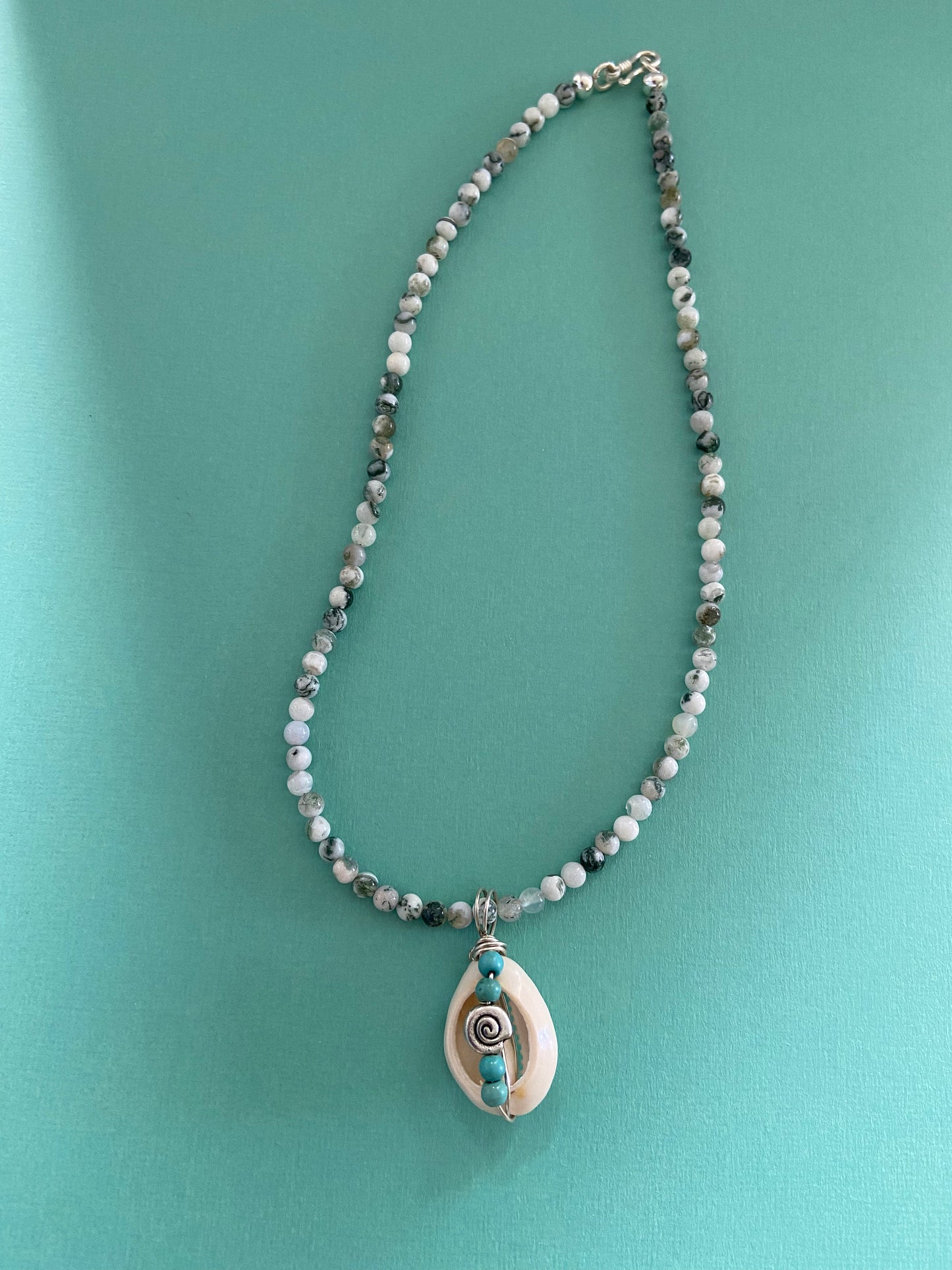 Cowrie shell  pendant wrapped in sterling silver designed with tiny turquoise coloured bead detail, Tree Agate gemstone necklace.